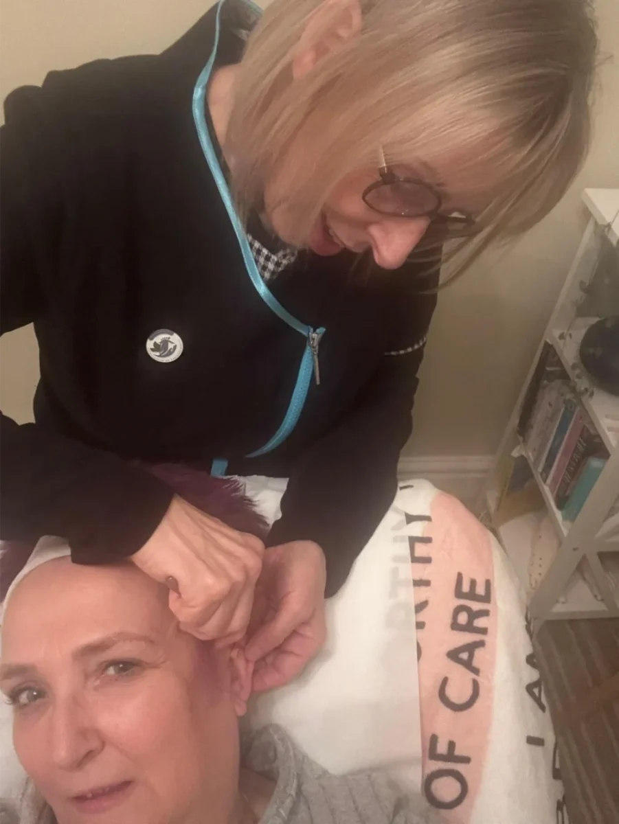 Photo_of_auricular_working Reflexology treatment session with therapist working on client